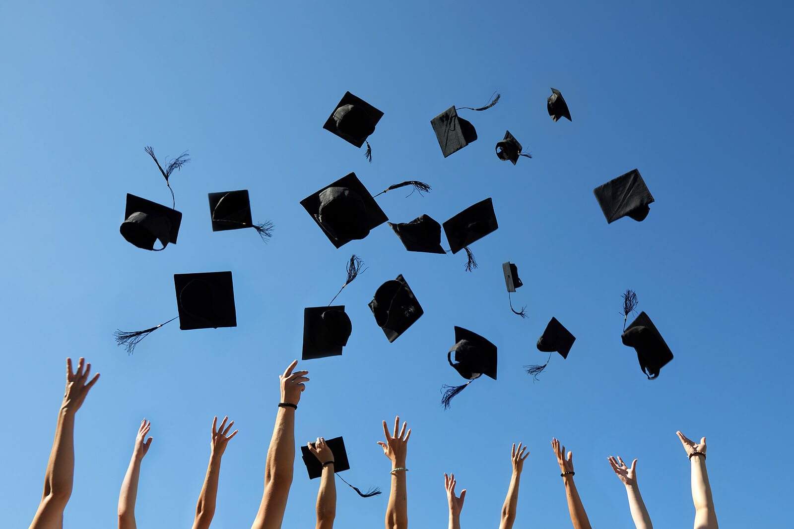 graduation-caps-air-blue-sky